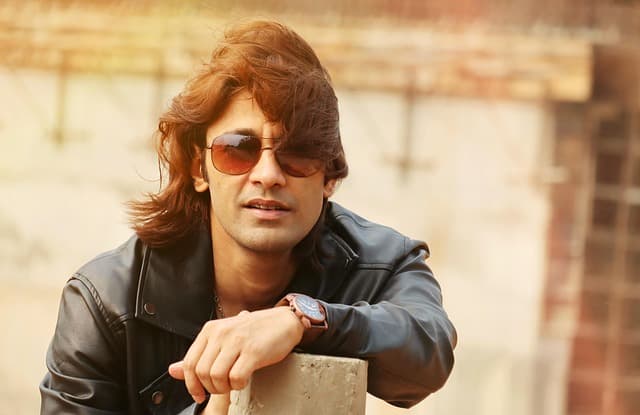 man model smile in sunglasses, hot fashion, attractive youth, blonde and beautiful, confident, elegant long hairstyles, street style, macho, desirable hot, commercial use, perfume for man, hot sexy indian, long haired male, isolated city, cool life, sexy man, stylish, charming, urban men fashion, action style, glamorous, men in sunshine, man wear leather blazer, sunlight leak, free to use